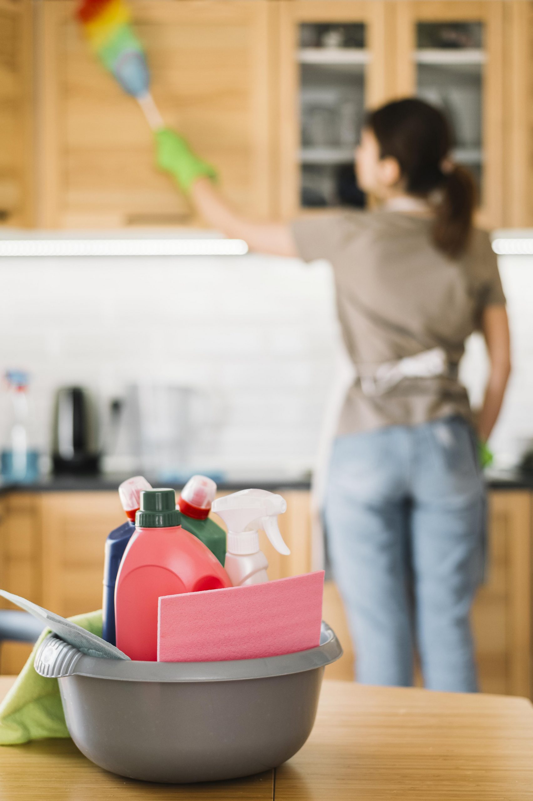 blurred woman using fluffy duster scaled