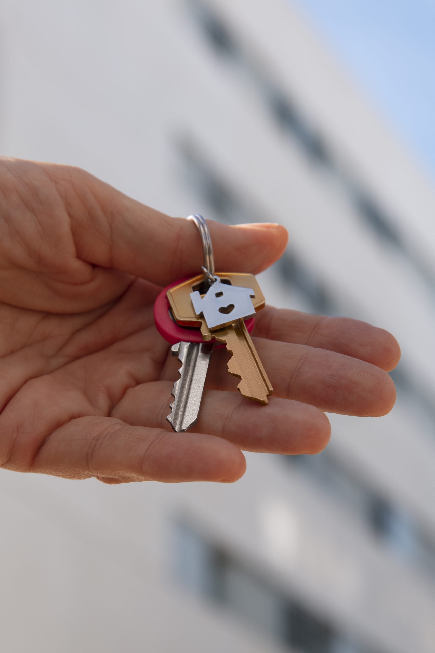 hand holding keys outdoors scaled